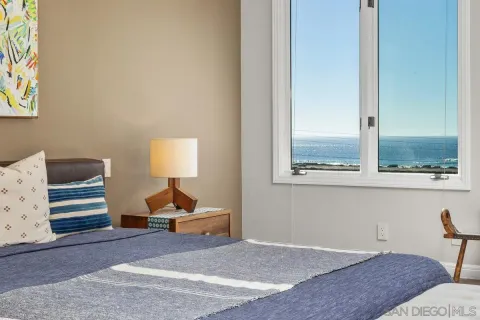 a spacious bedroom with a bed and a fireplace