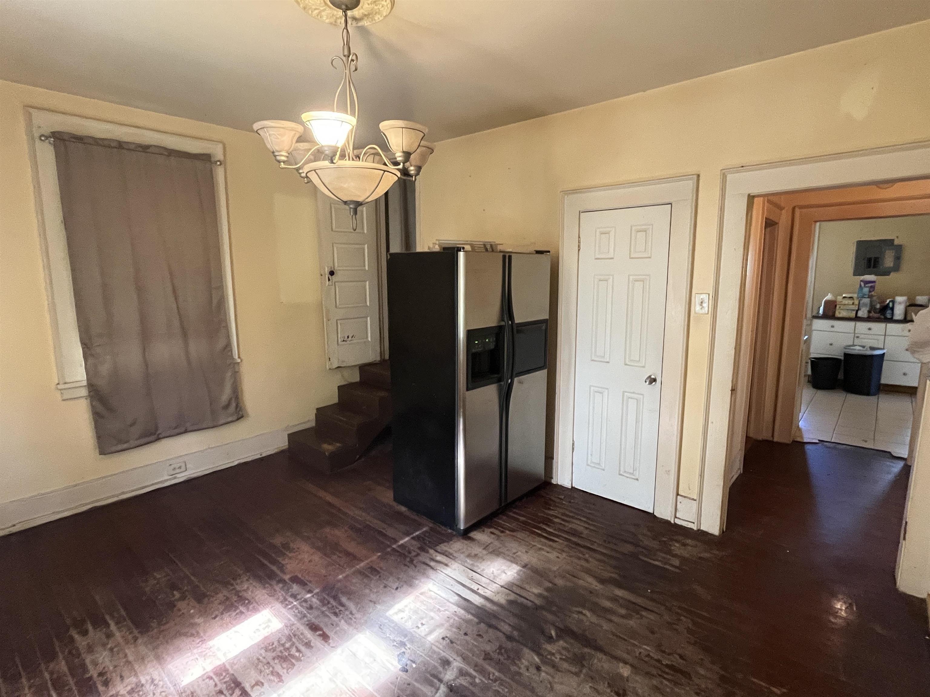 211 4th Street Mobile, AL 36611 - Photo 14 of 34 Unfurnished dining area with dark wood-style flooring, hanging lights, and electric panel