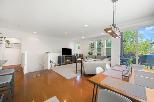 a living room with furniture a flat screen tv and a large window