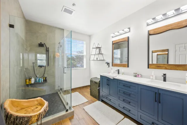 a bathroom with a double vanity sink and a mirror