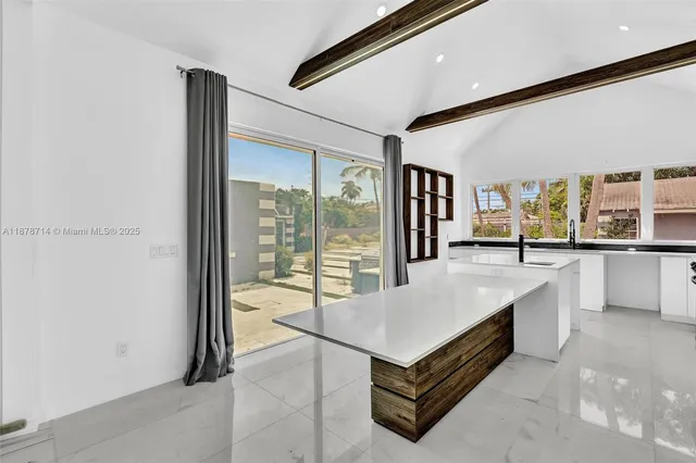 a kitchen with a refrigerator and a sink