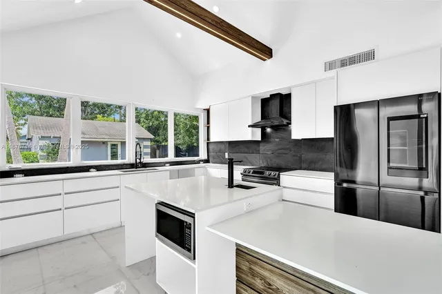 a kitchen with granite countertop a cabinets and a stove top oven