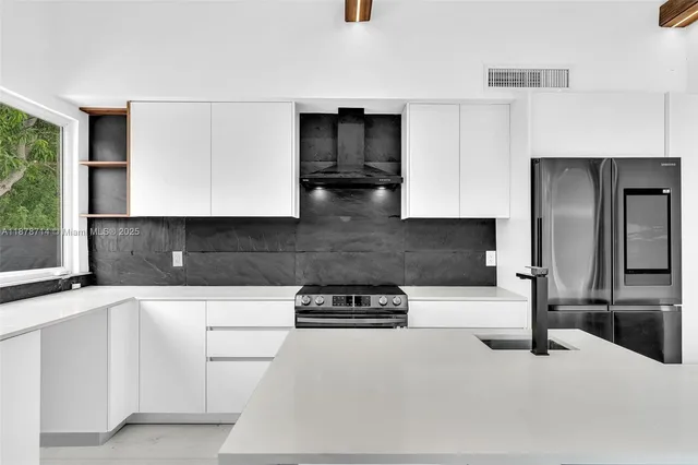 a kitchen with kitchen island white cabinets and white appliances
