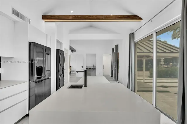 a kitchen with stainless steel appliances granite countertop a stove and a refrigerator