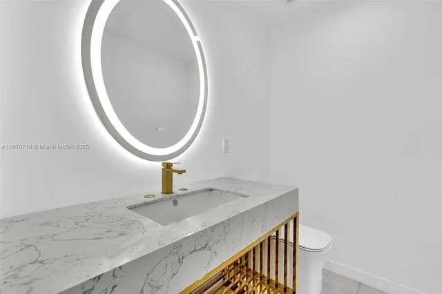 a view of a patio with couches and table and chairs under an umbrella