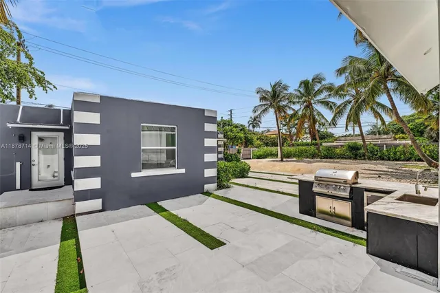 a view of a kitchen with a sink and a refrigerator