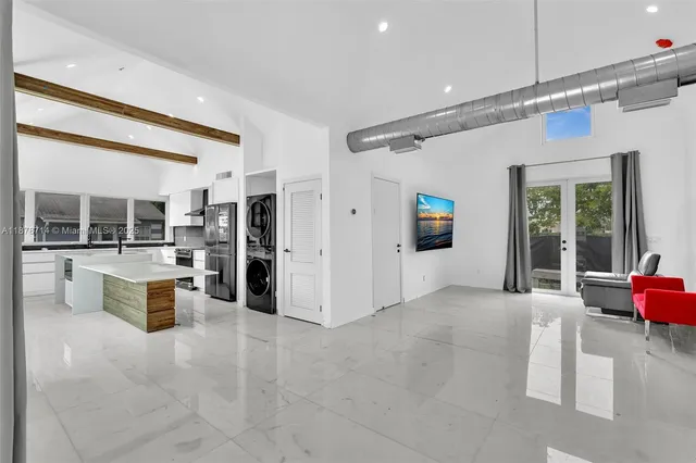 a bedroom with a large bed and a large window