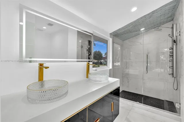 a view of a kitchen with a sink and dishwasher with wooden floor