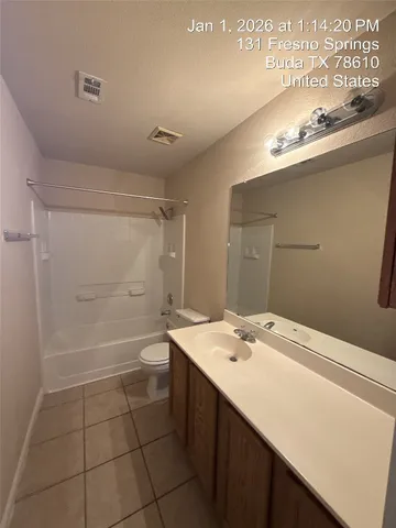 a view of an empty room with a ceiling fan