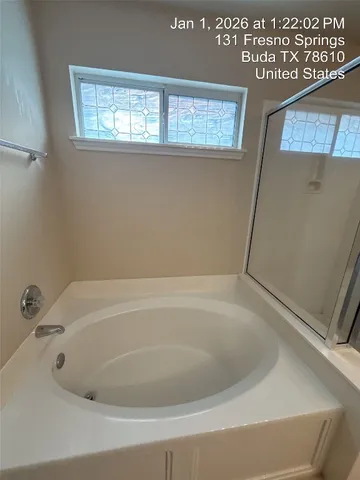 a bathroom with a bathtub and a shower