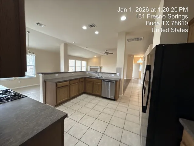 a backyard of a house with large trees and brick walls