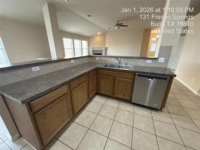 a large kitchen with a large counter top and stainless steel appliances