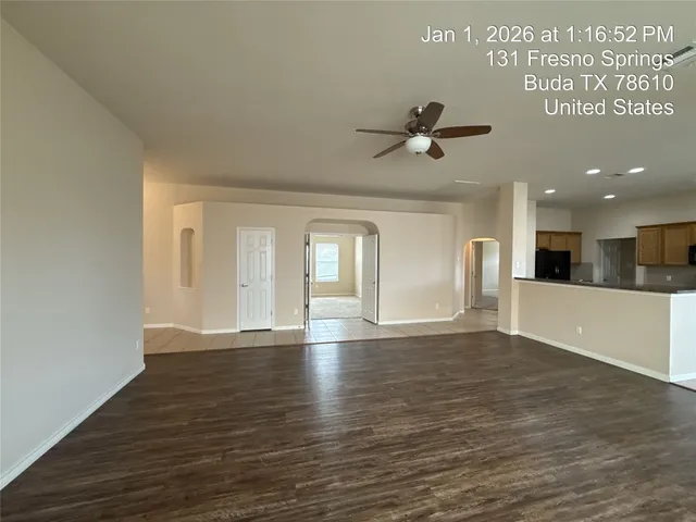an empty room with wooden floor and fireplace