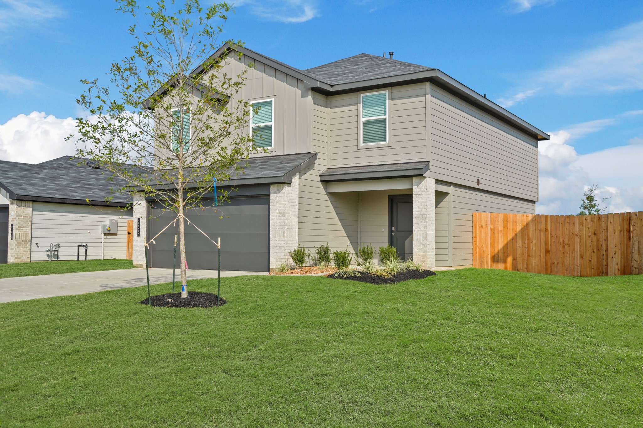 953 Sutherland Falls Conroe, TX 77303 - Photo 2 of 27 a front view of a house with a yard