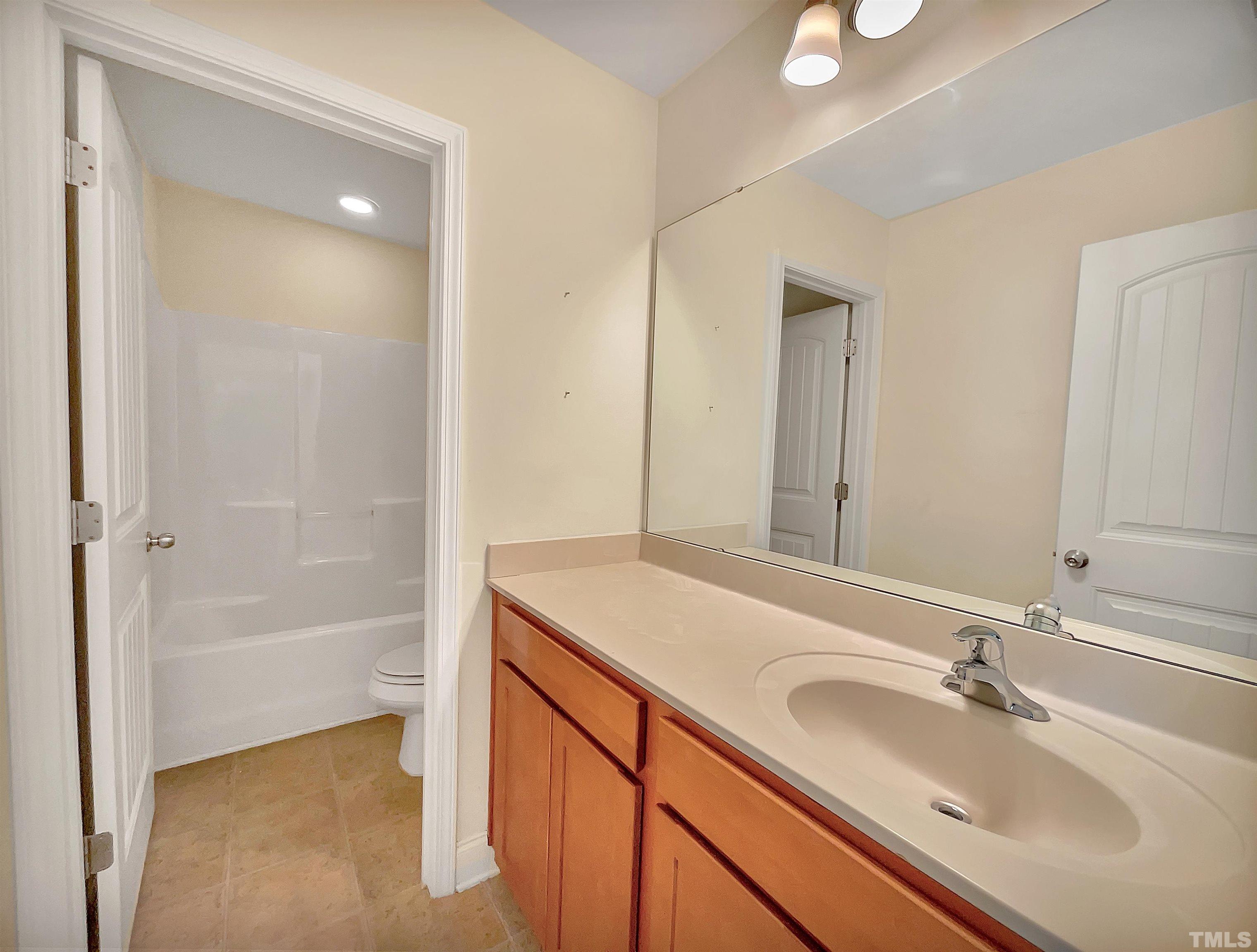 2709 Communion Court Raleigh, NC 27610 - Photo 12 of 18 a bathroom with a sink and a mirror