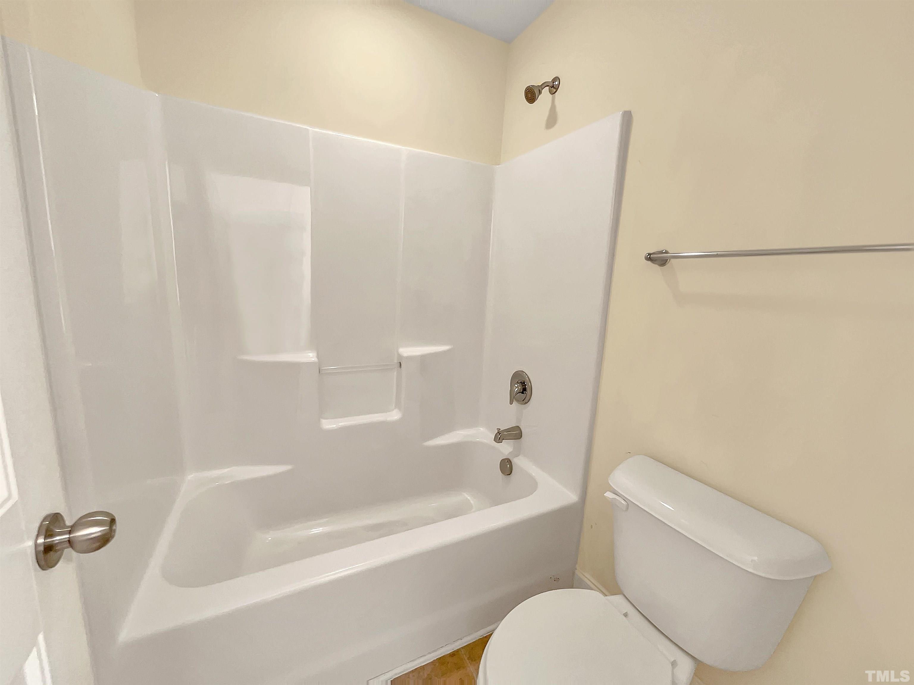 2709 Communion Court Raleigh, NC 27610 - Photo 13 of 18 a white bath tub sitting next to a white toilet and sink