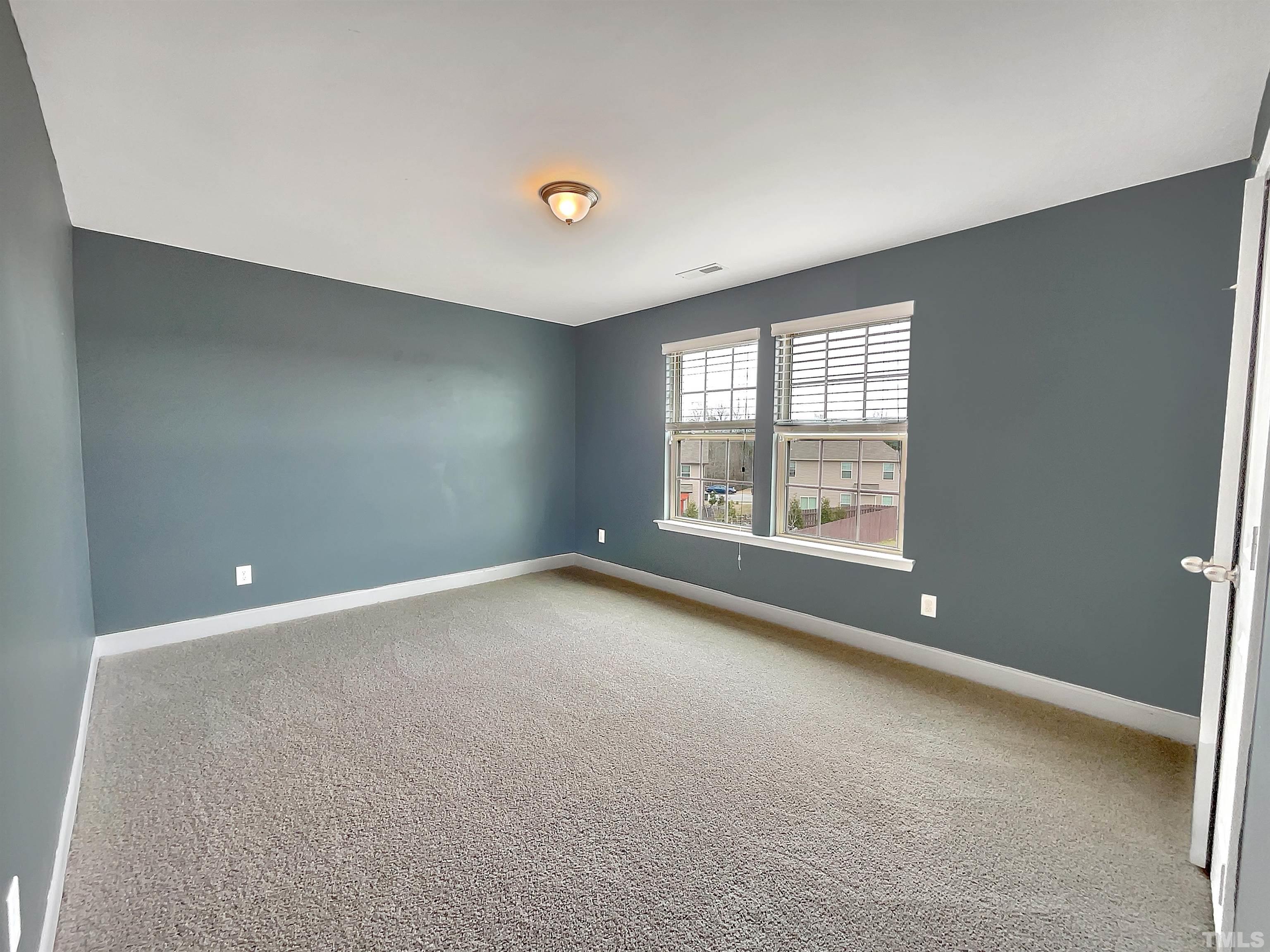 2709 Communion Court Raleigh, NC 27610 - Photo 14 of 18 an empty room with windows