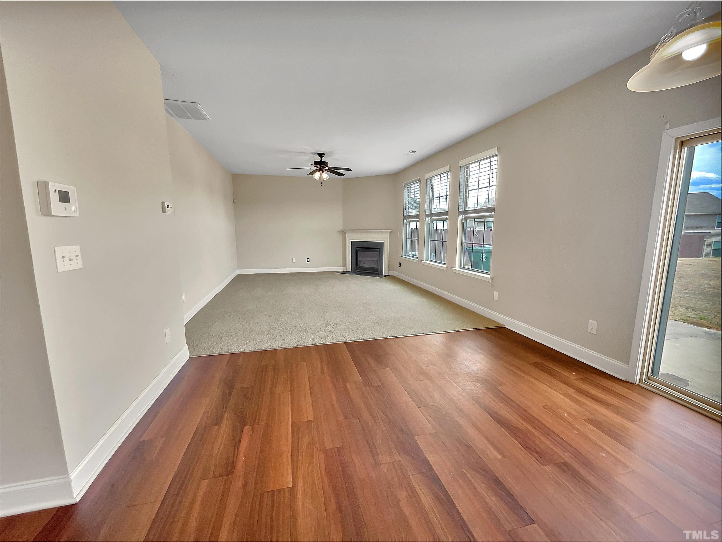 2709 Communion Court Raleigh, NC 27610 - Photo 3 of 18 wooden floor in an empty room with a window