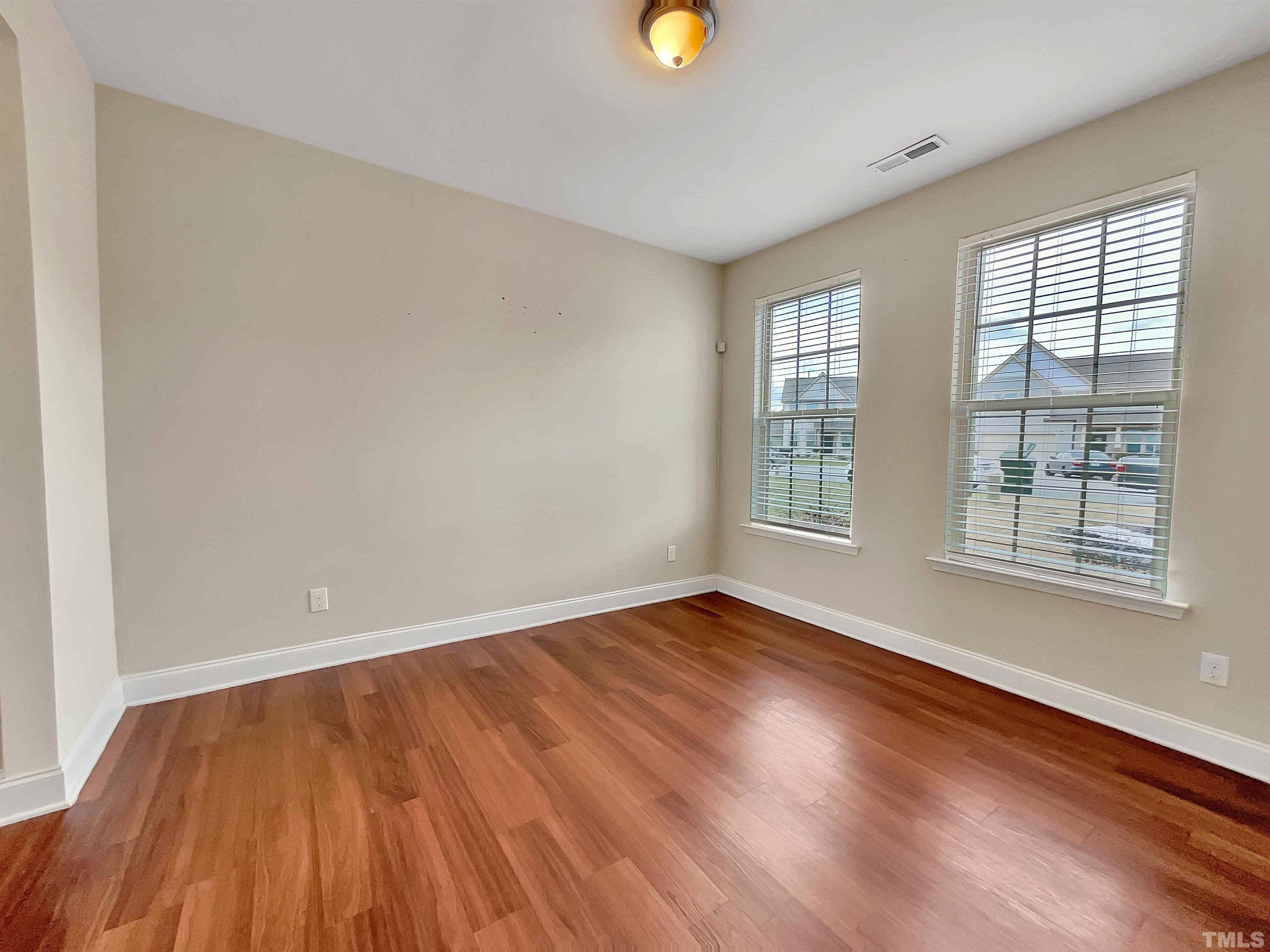 2709 Communion Court Raleigh, NC 27610 - Photo 7 of 18 a view of an empty room with wooden floor and a window