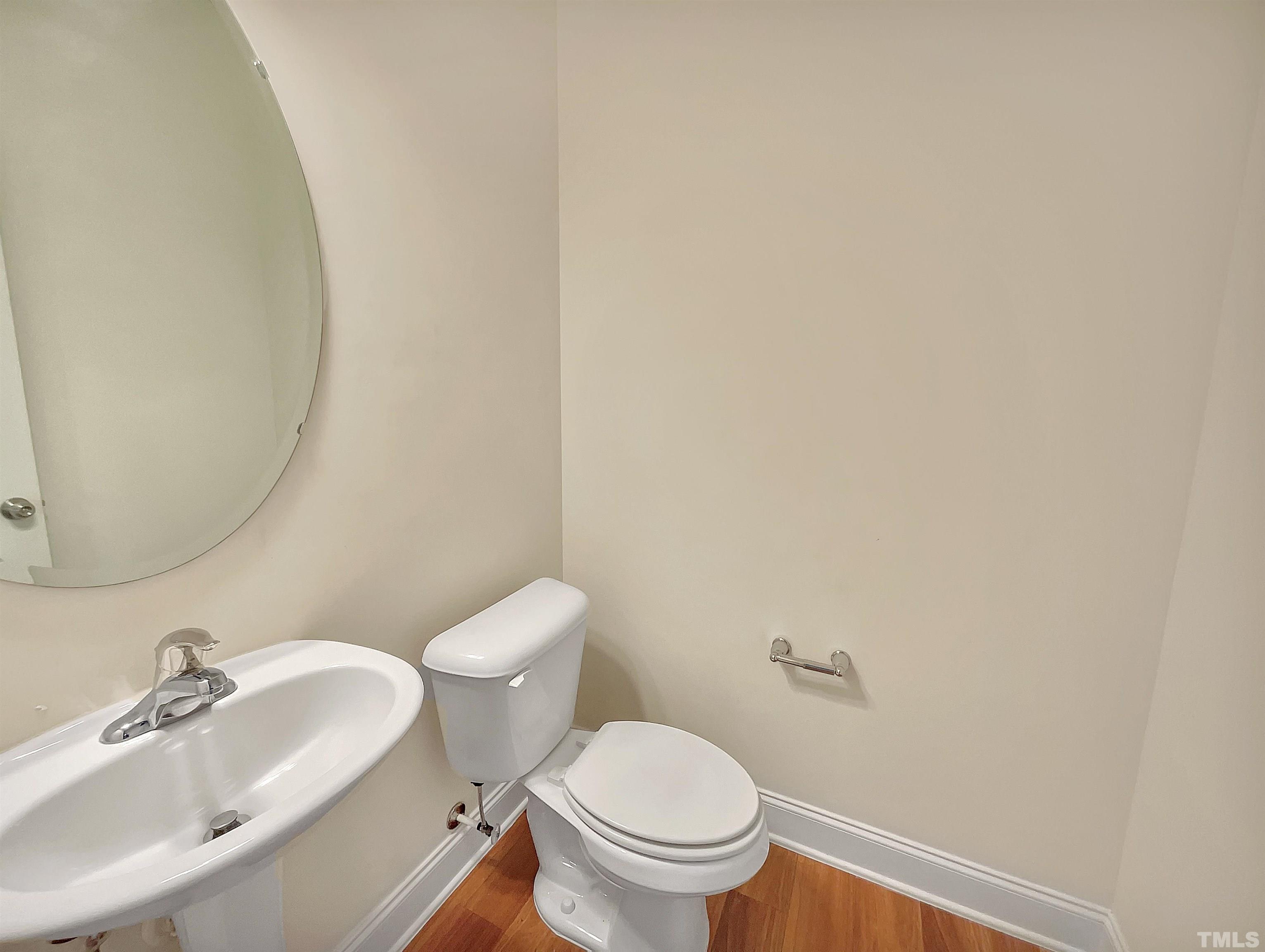2709 Communion Court Raleigh, NC 27610 - Photo 8 of 18 a white toilet sitting next to a bathroom sink