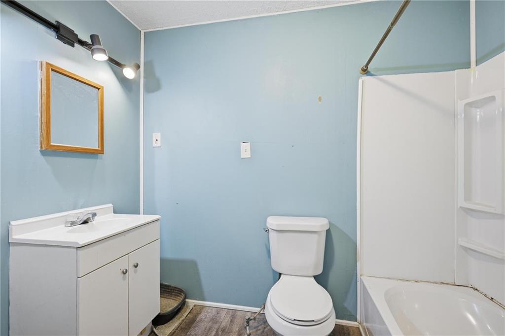 415 Tapley Road Villa Rica, GA 30180 - Photo 22 of 25 a bathroom with a toilet sink and mirror