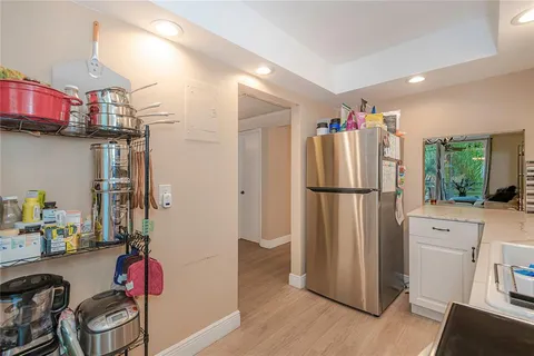 a kitchen with stainless steel appliances granite countertop a refrigerator and a stove