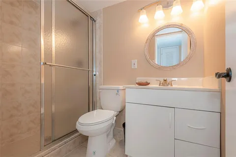 a bathroom with a toilet a sink and a mirror