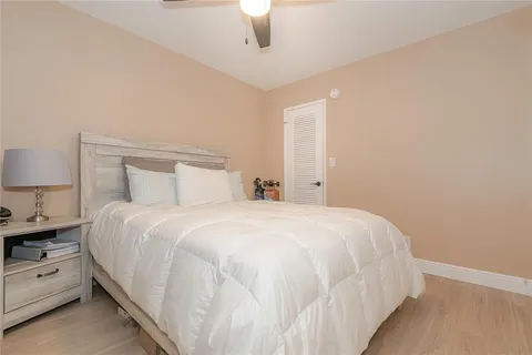 a bedroom with a bed and a lamp