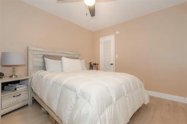 a bedroom with a bed and a lamp