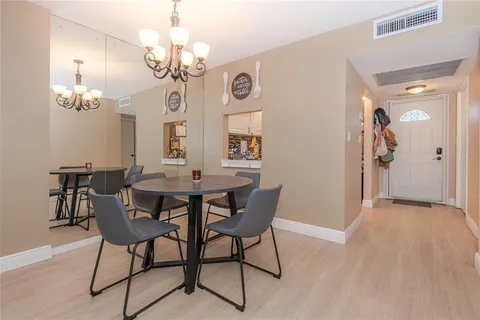 a view of a dining room with furniture and chandelier