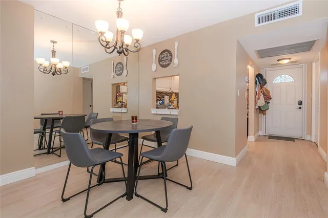 a view of a dining room with furniture and chandelier