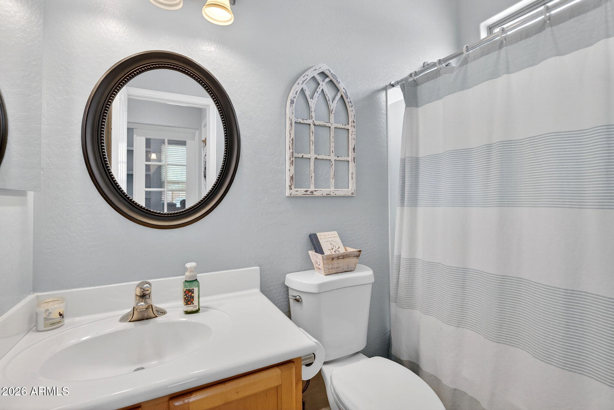 6280 South Sinova Court Gilbert, AZ 85298 - Photo 9 of 64 a bathroom with a sink a mirror a toilet and a sink