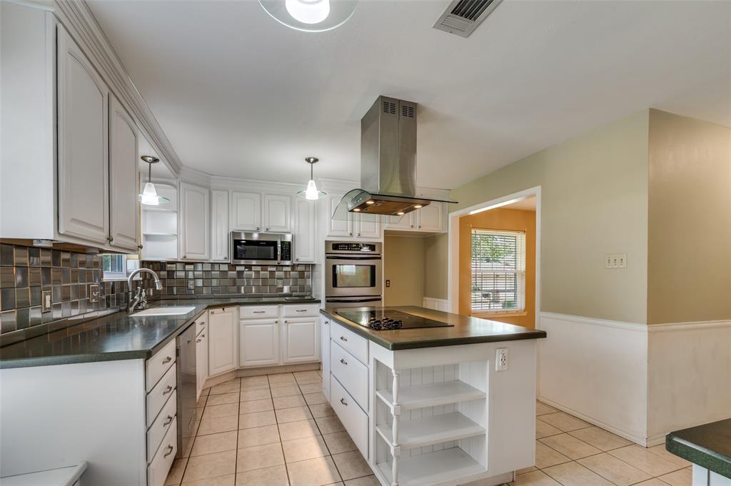 1501 Ridgeview Drive Arlington, TX 76012 - Photo 11 of 32 a kitchen with stainless steel appliances a sink a stove top oven a counter space and cabinets