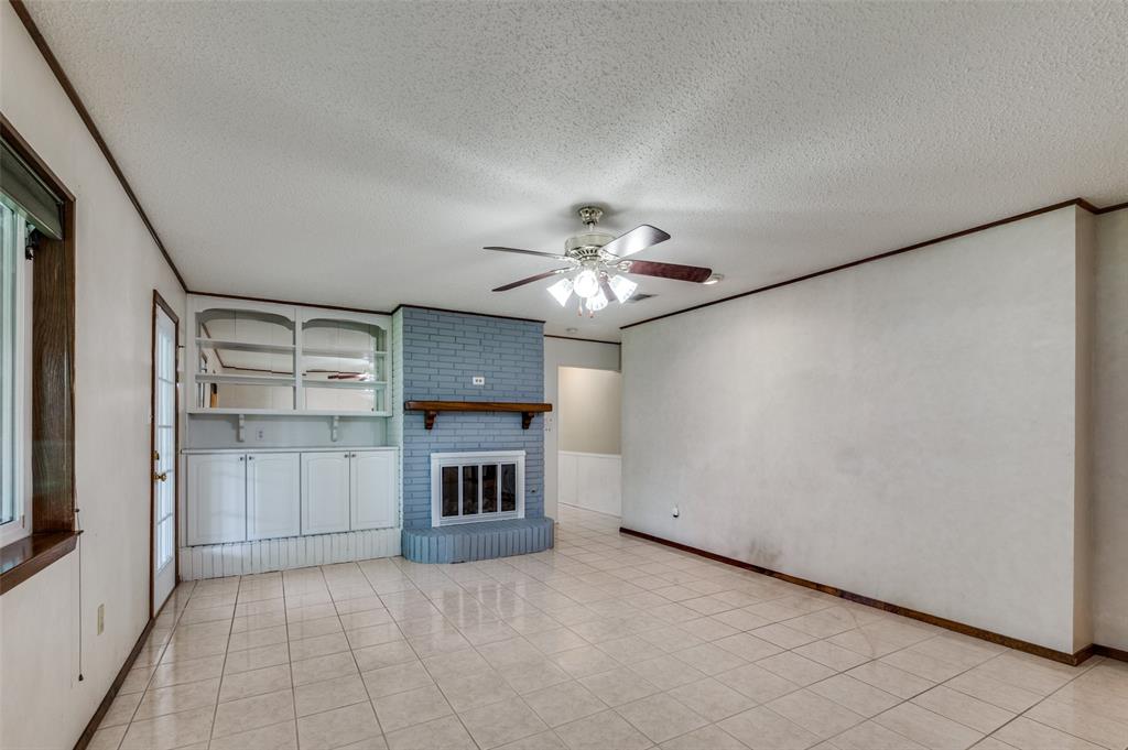 1501 Ridgeview Drive Arlington, TX 76012 - Photo 16 of 32 a view of a livingroom with a fireplace and a ceiling fan