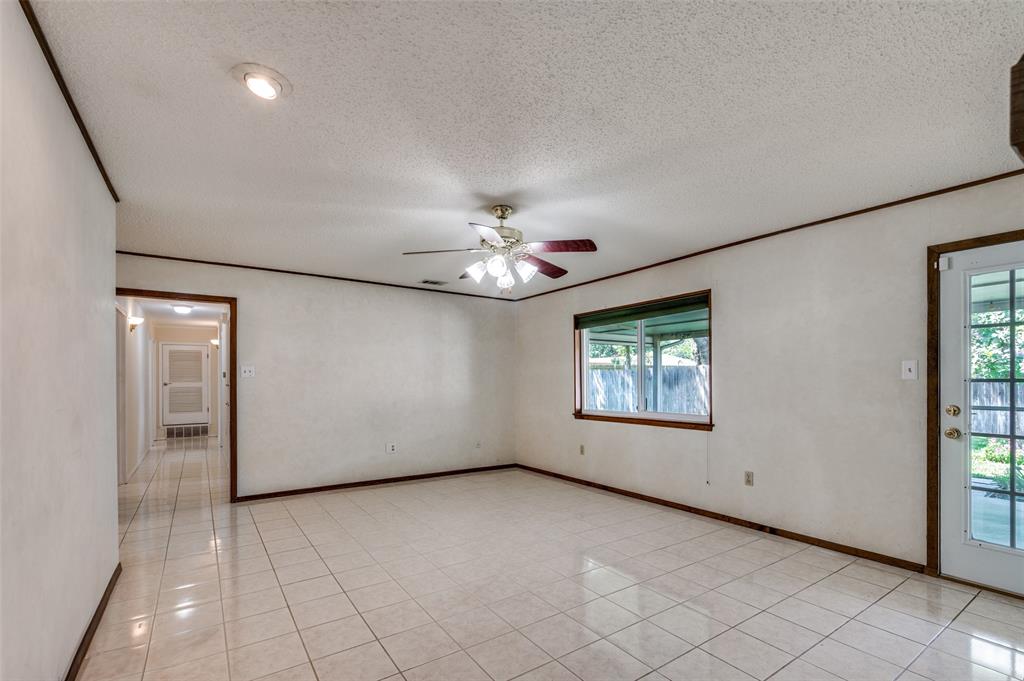 1501 Ridgeview Drive Arlington, TX 76012 - Photo 18 of 32 an empty room with chandelier fan and windows