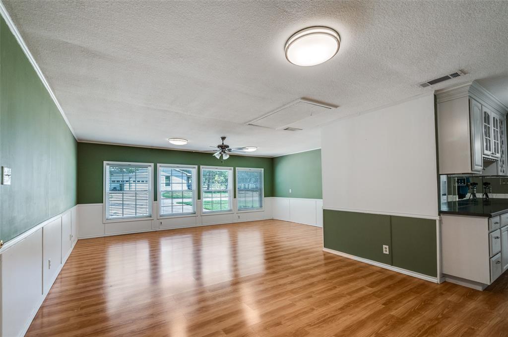 1501 Ridgeview Drive Arlington, TX 76012 - Photo 19 of 32 a view of an empty room with wooden floor and a window