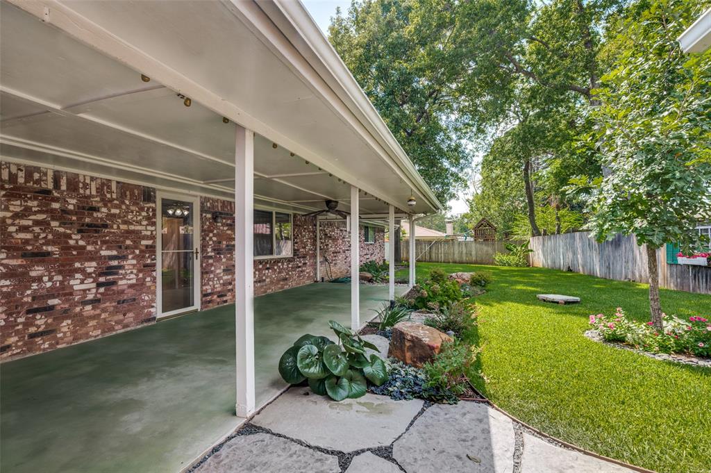 1501 Ridgeview Drive Arlington, TX 76012 - Photo 31 of 32 a view of a porch with a big yard potted plants and large tree