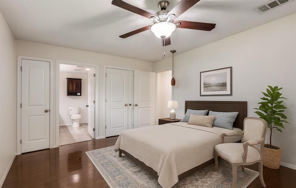 1501 Ridgeview Drive Arlington, TX 76012 - Photo 4 of 32 a bedroom with a large bed and a chandelier