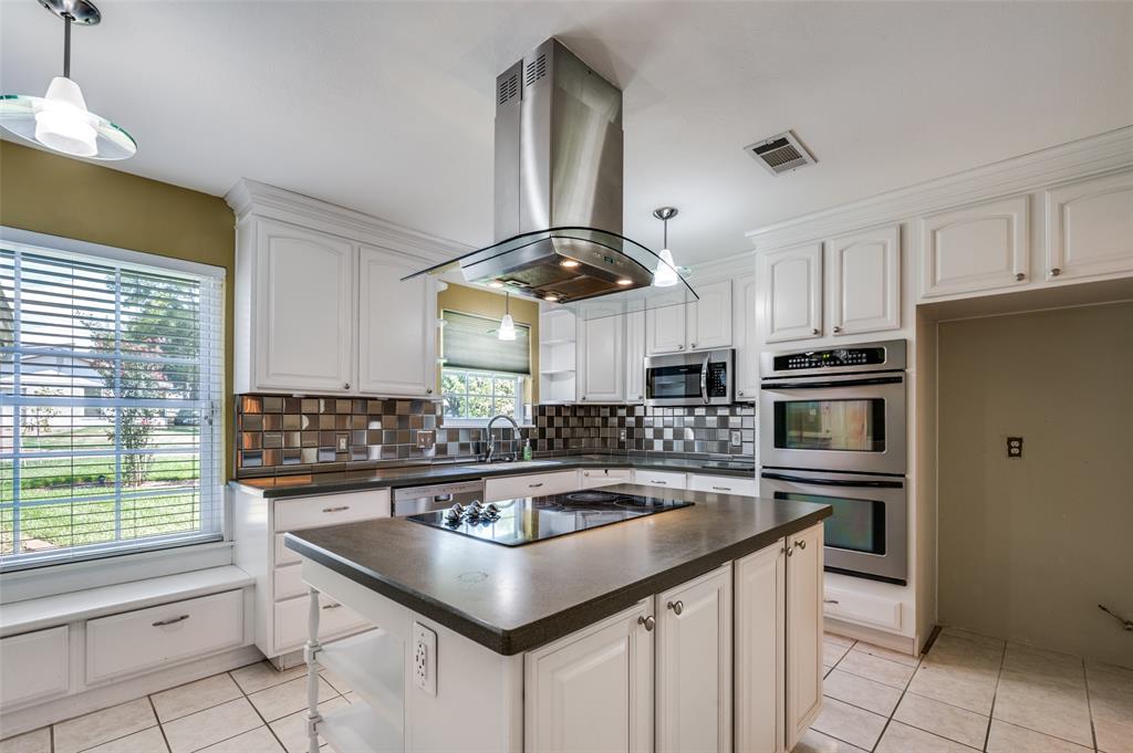 1501 Ridgeview Drive Arlington, TX 76012 - Photo 10 of 32 a kitchen with stainless steel appliances a sink a stove a refrigerator cabinets and a window