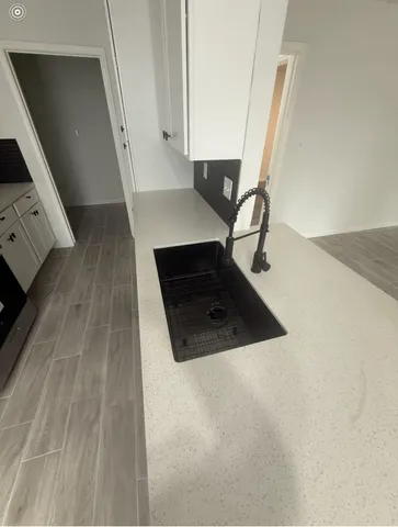 a kitchen with a sink and cabinets