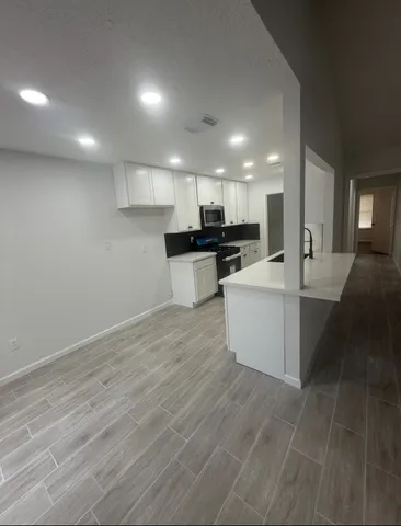 a view of hallway with wooden floor