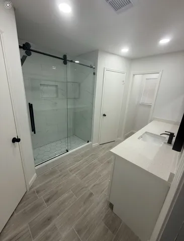 a bathroom with a shower and a sink