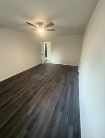 a view of a hallway with wooden floor