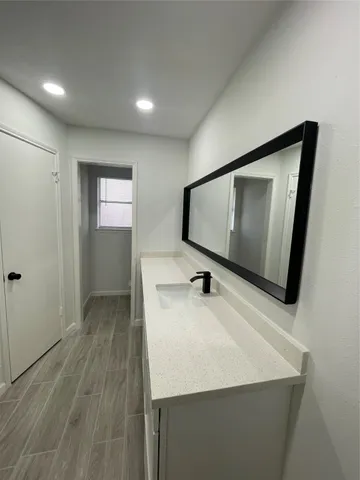 a kitchen with stainless steel appliances a stove microwave and sink