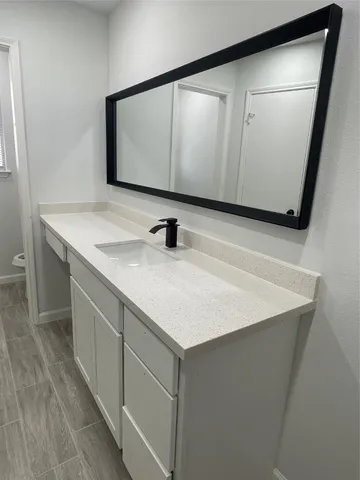 a view of kitchen with microwave a refrigerator and cabinets
