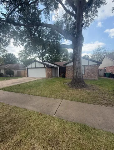 a view of a house with a yard and garage