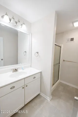 a spacious bathroom with a double vanity sink mirror and toilet