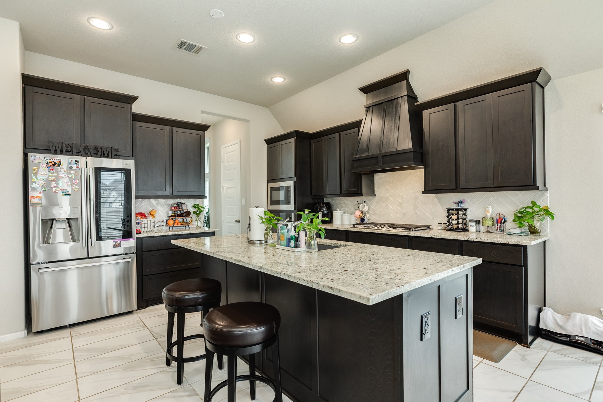 5138 Walnut Grv Lane Manvel, TX 77578 - Photo 13 of 43 a kitchen with granite countertop a refrigerator stove microwave and sink