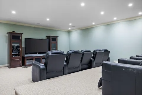 a projector room with furniture and a flat screen tv