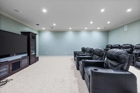 a media room with lots of chairs and a projector screen